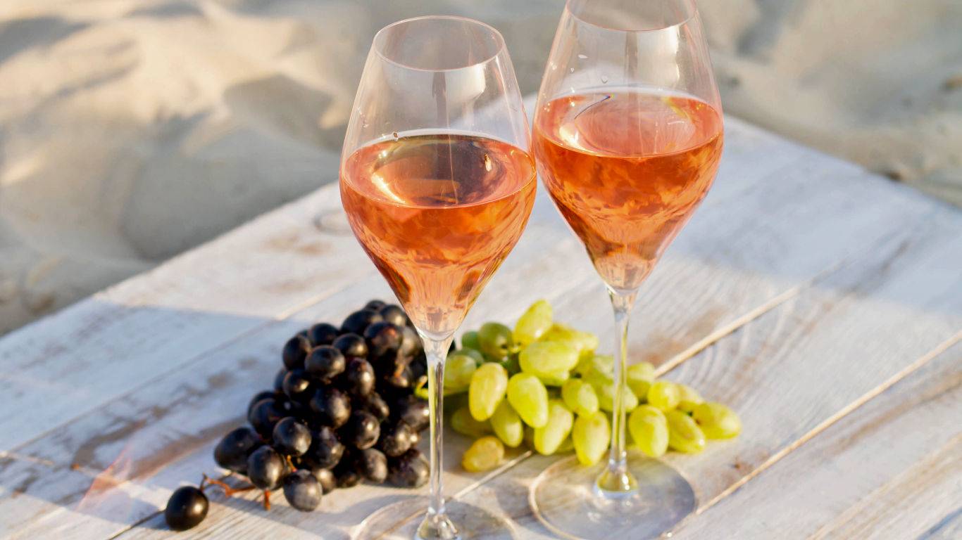Glasses of rose wine on the beach