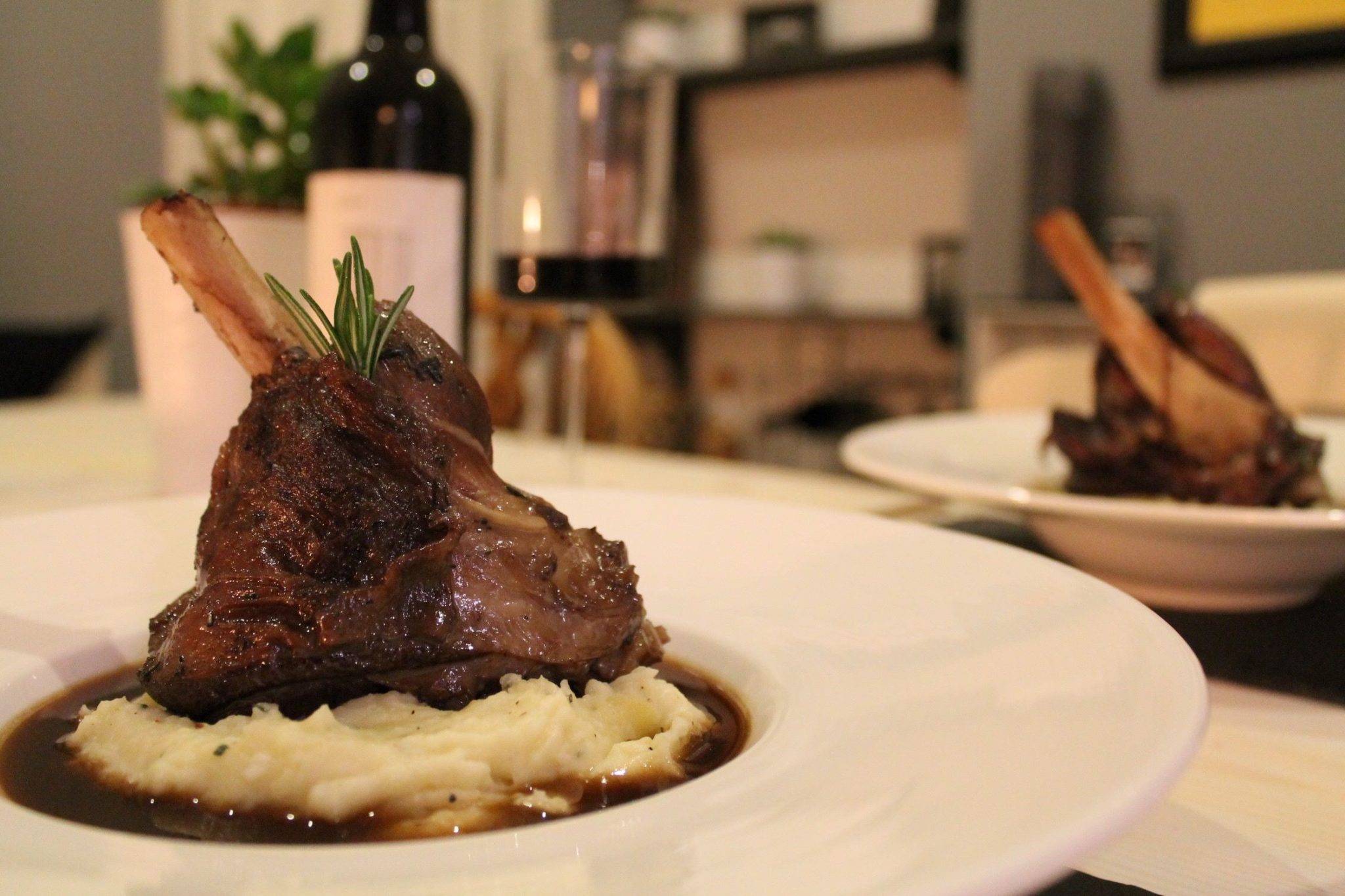 Slow braised lamb shank with mash on a plate