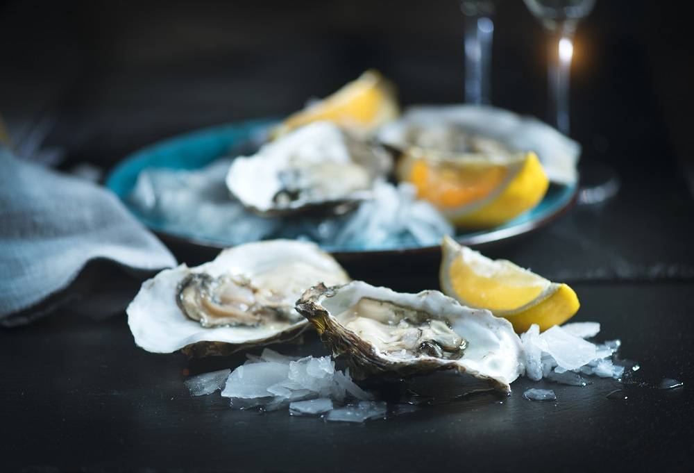 oysters on ice with lemon slices
