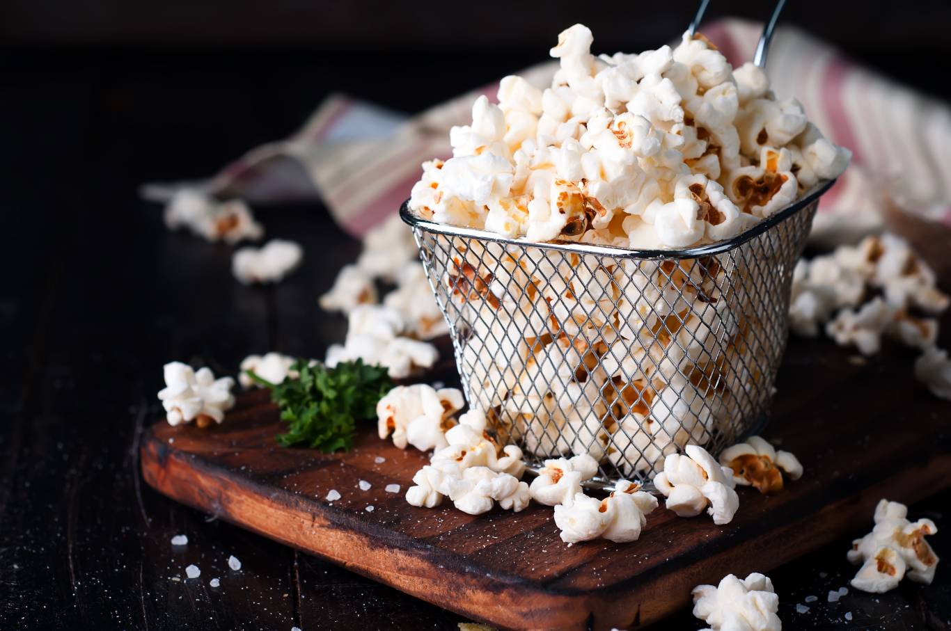 Salt popcorn in a basket on the wooden table