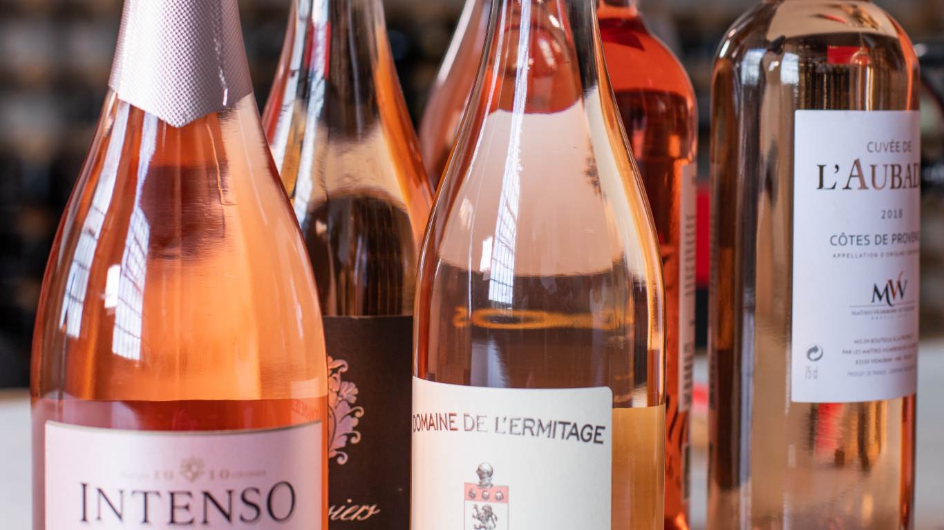 Close up of bottles of rose lined up on a table