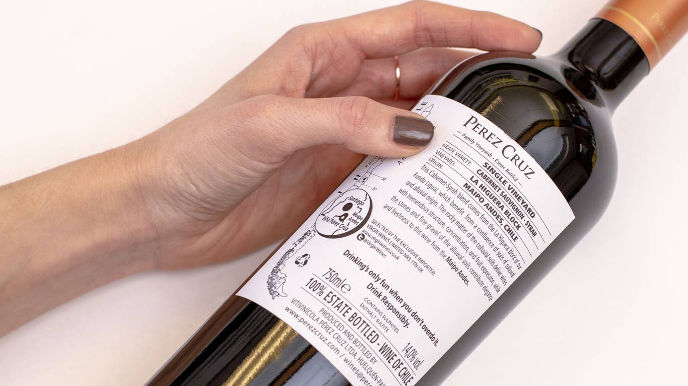 Woman reading the back of a wine label