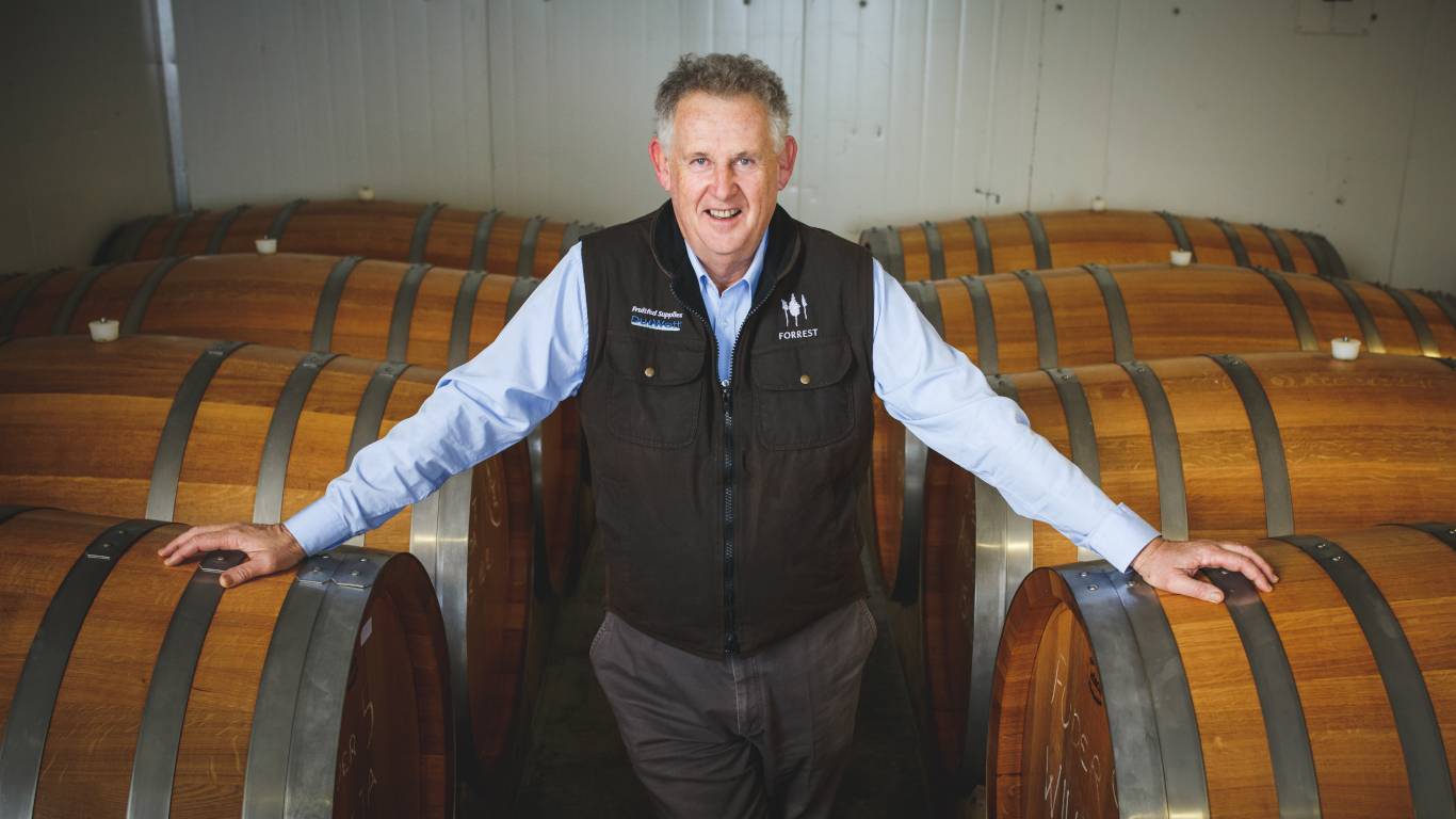 Dr John Forrest with barrels of wine