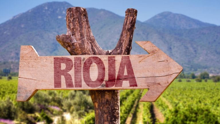 Signpost pointing to Rioja in a vineyard