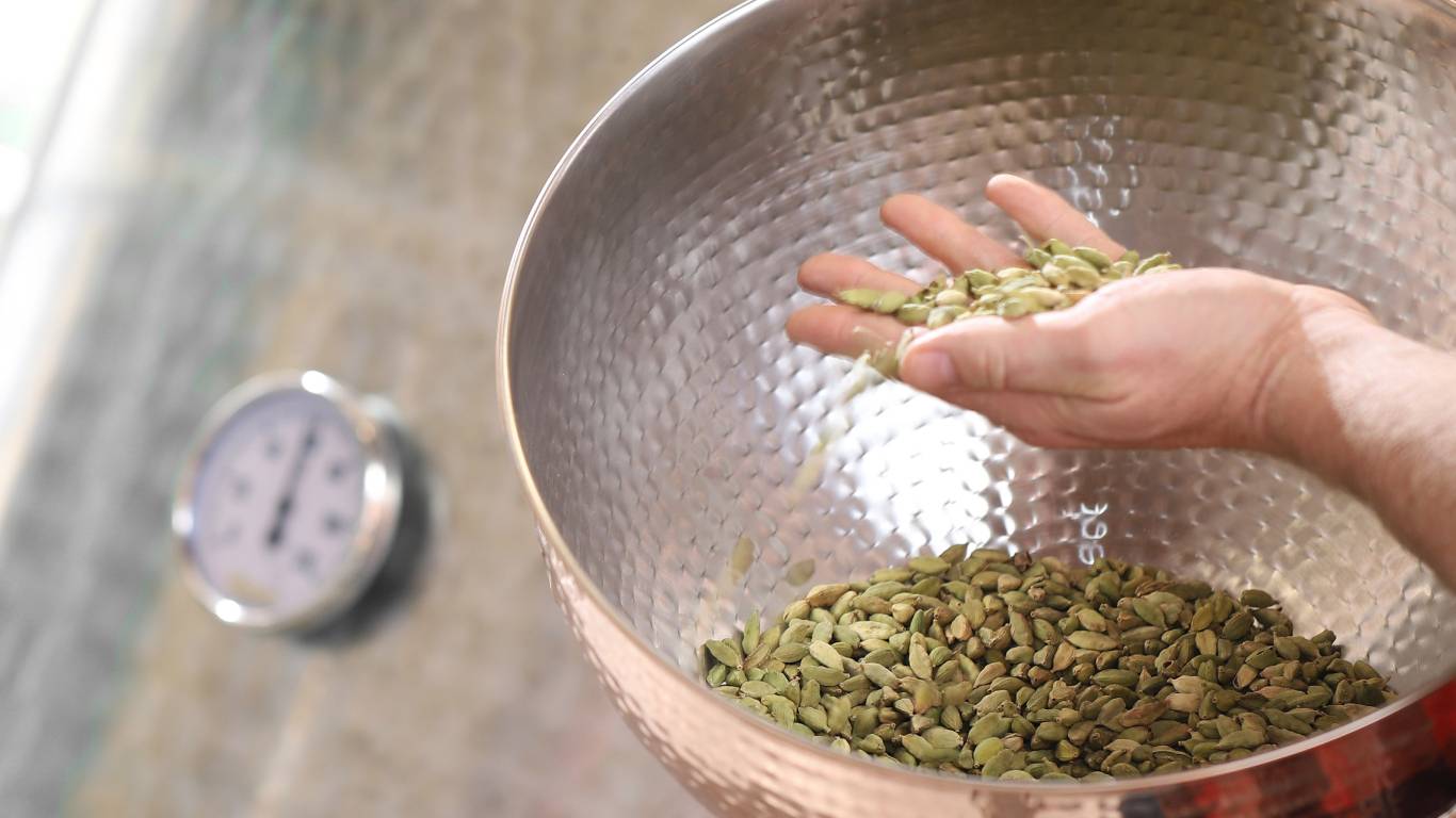 Green cardamom seeds being used as a botanical in gin