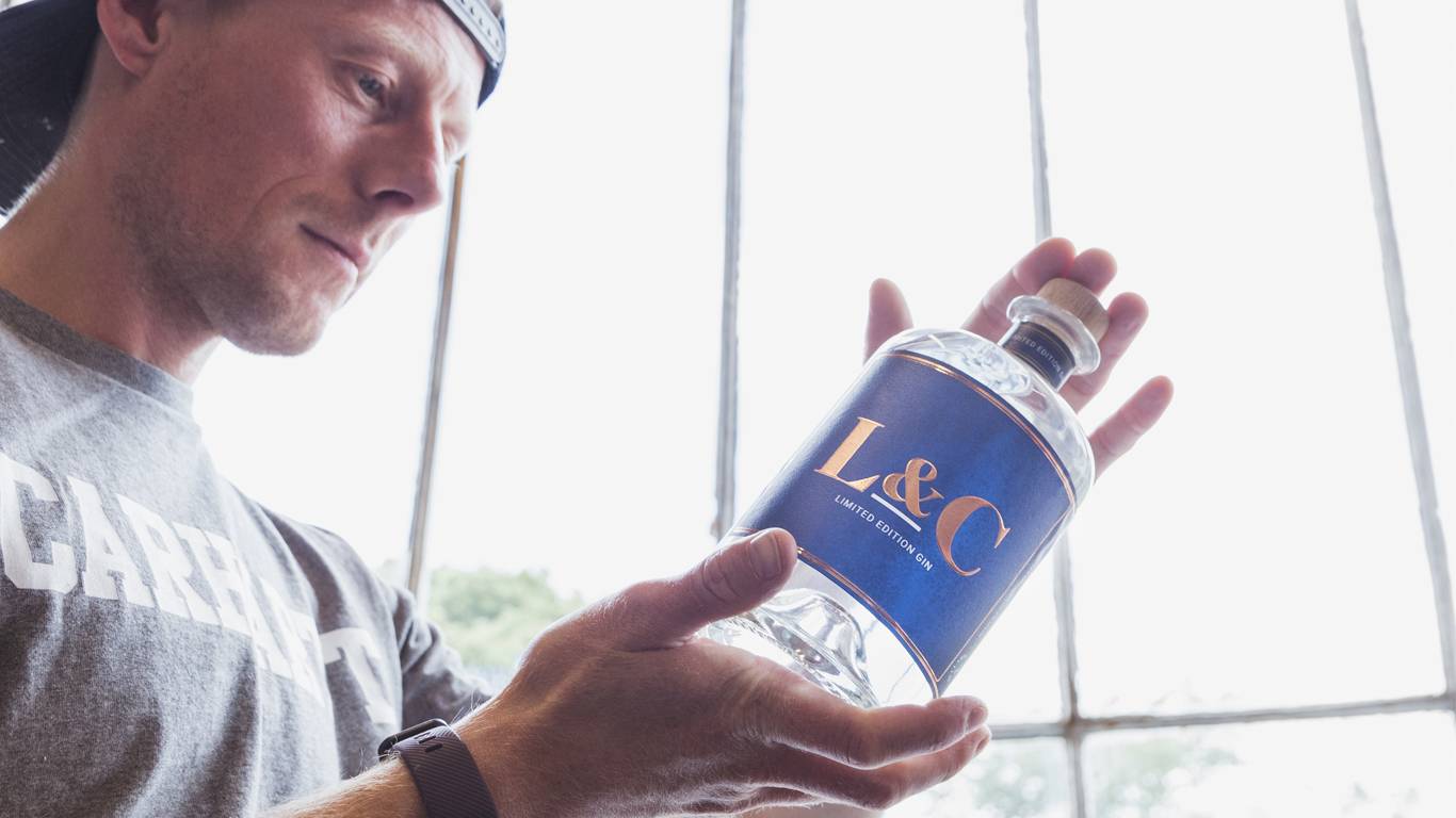 Our Spirits Buyer Dave holding up a bottle of L&C Gin in Bullards Distillery