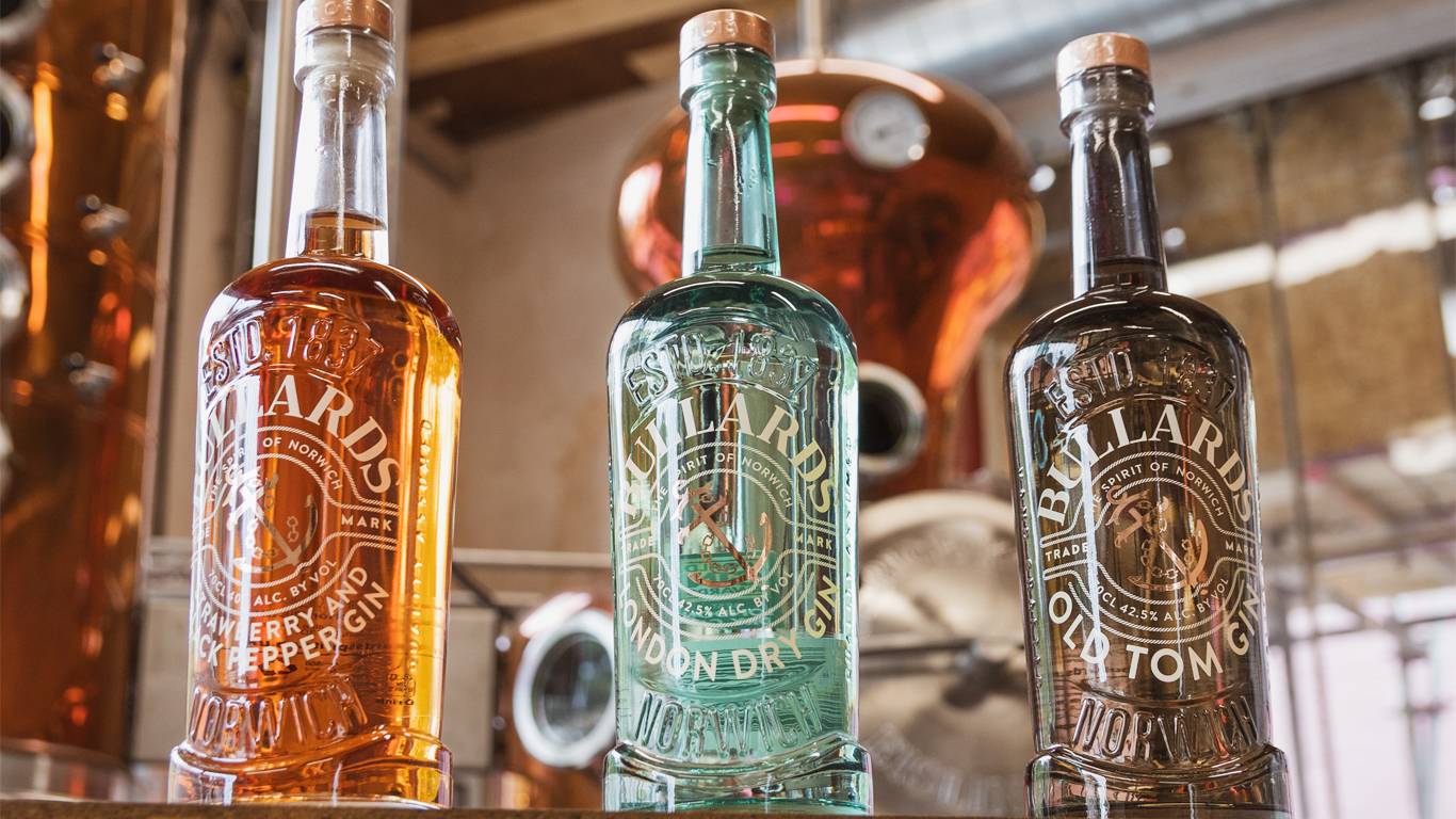 Range of Bullards gins in from of column stills in distillery