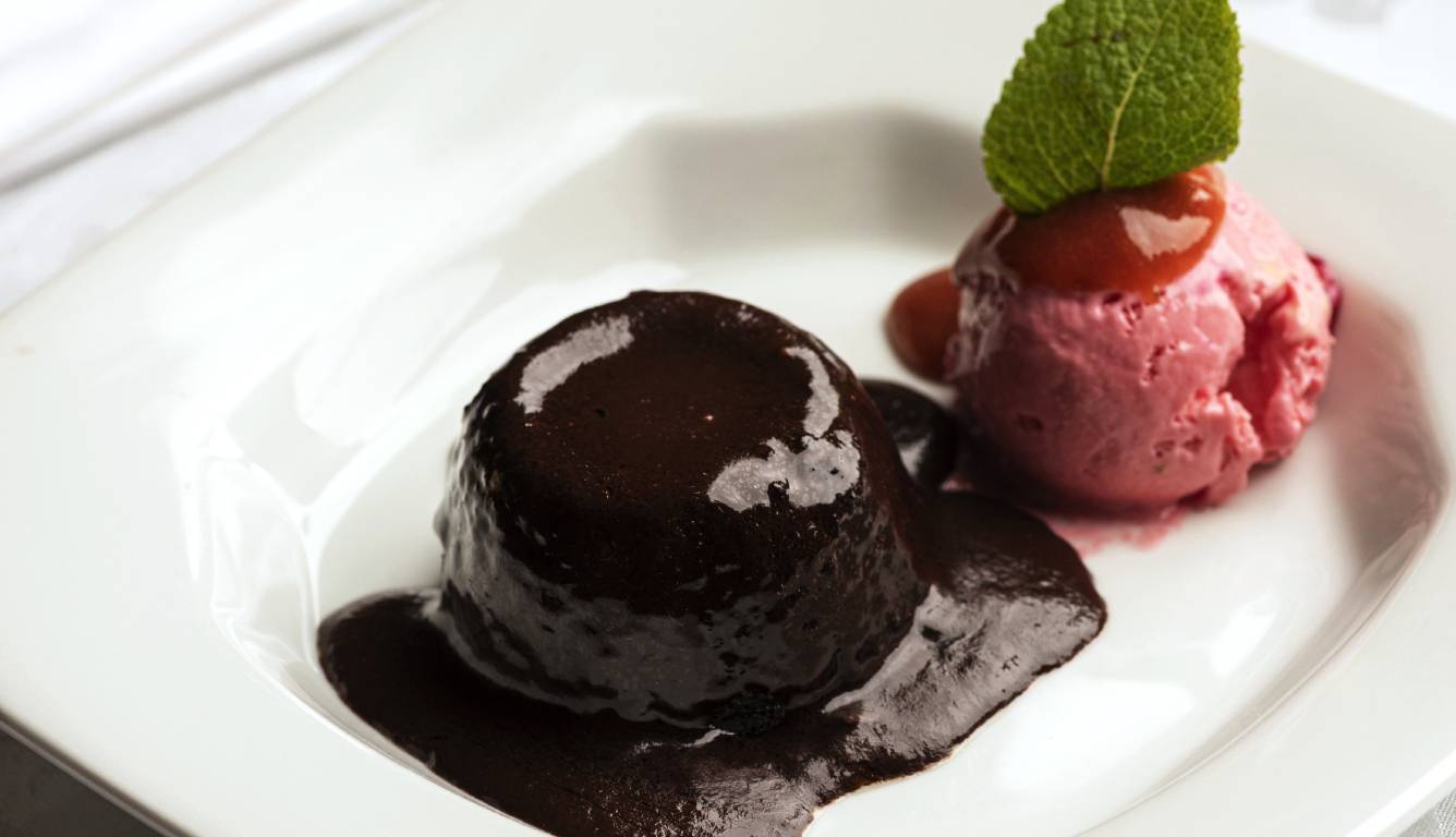 Chocolate pudding with strawberry ice cream on plate