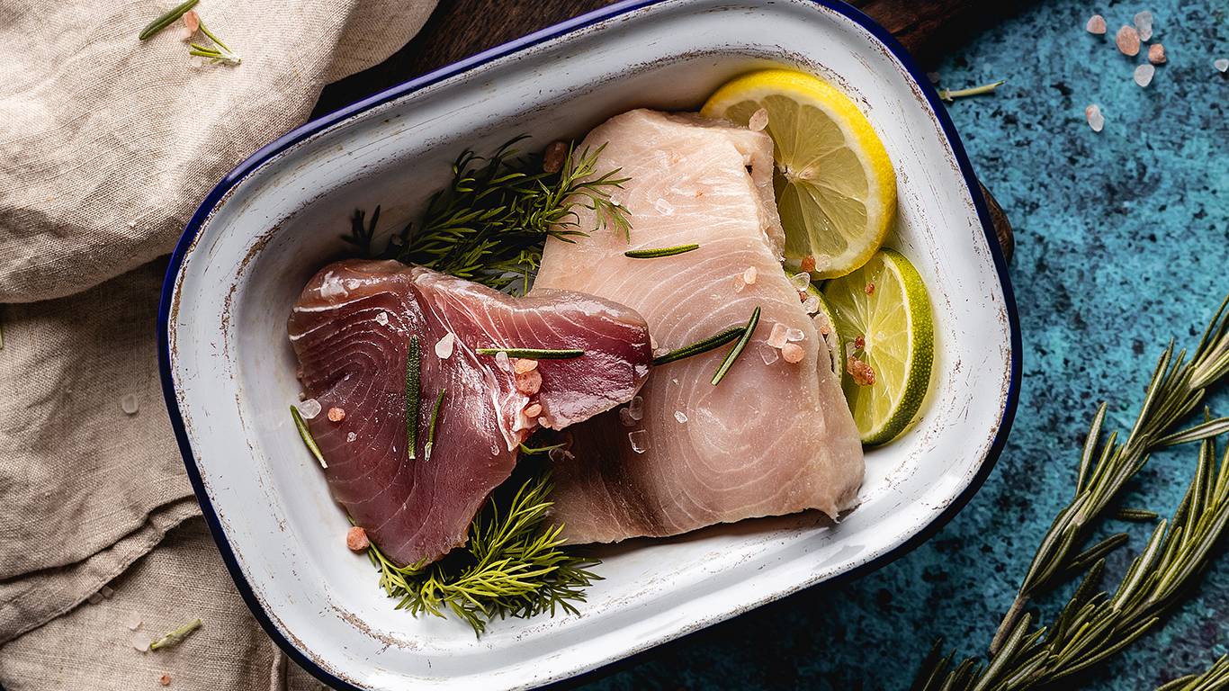 Meaty fish, tuna steaks in a roasting dish ready to cook