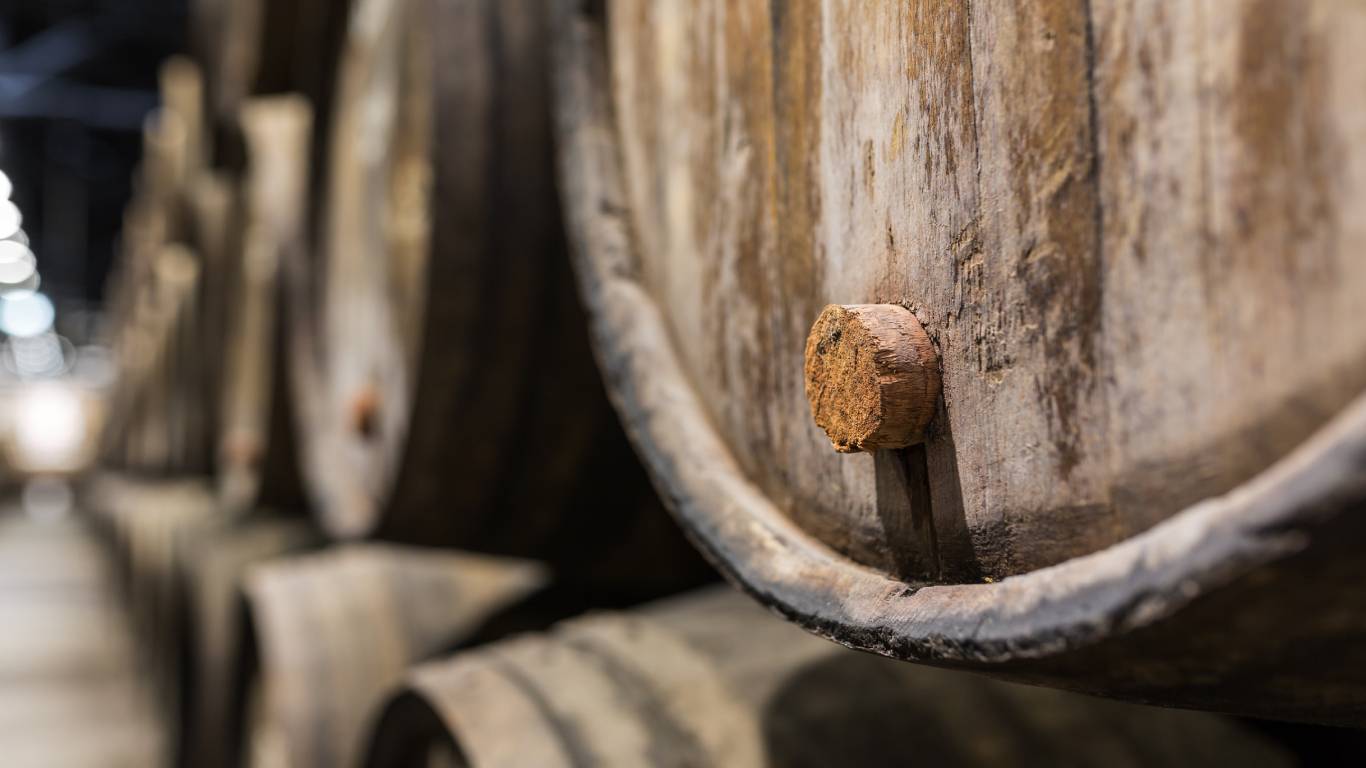 Wooden port wine barrel in wine cellar of Porto, Portugal