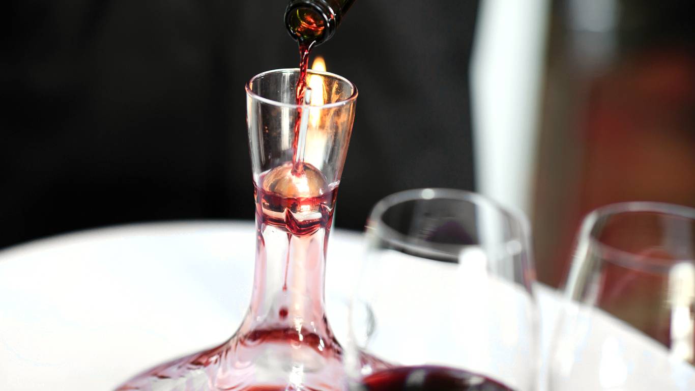 Pouring red wine into a decanter