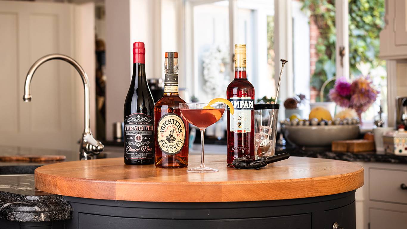 Boulevardier cocktail and ingredients in kitchen