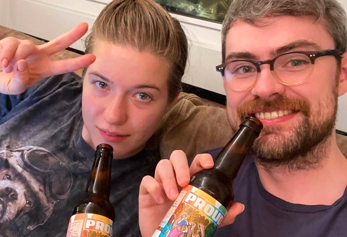 Two people drinking PROUD beer