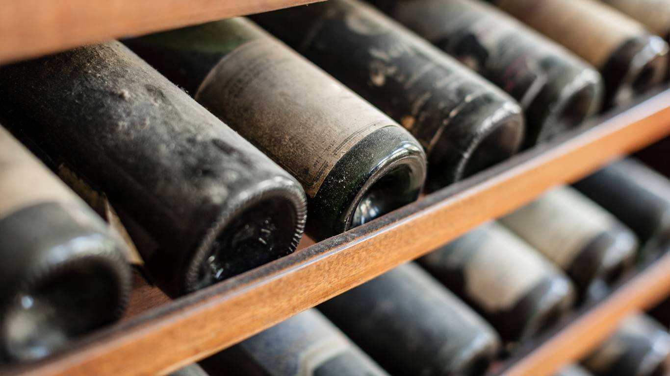 Dusty wine bottles in a wine rack storage