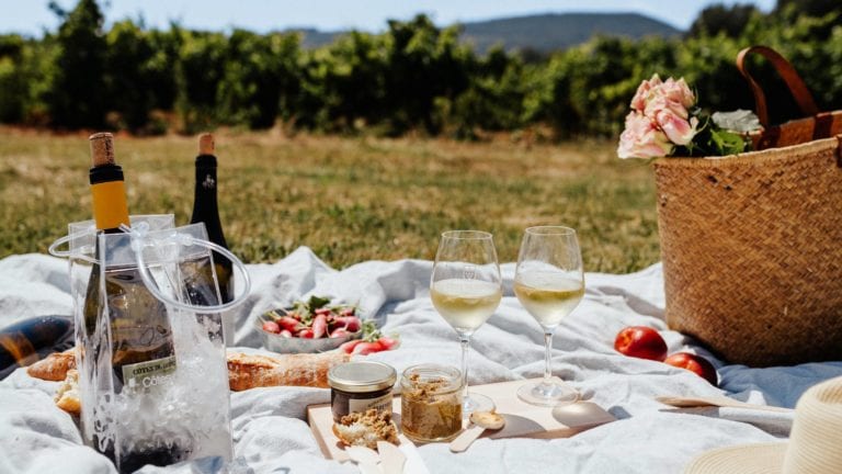 White Rhone wine picnic outside with picked flowers, copyright Camille Meffre