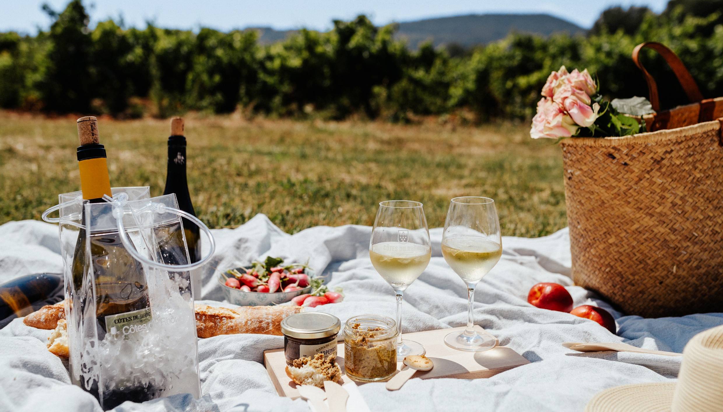 White Rhone wine picnic outside with picked flowers, copyright Camille Meffre