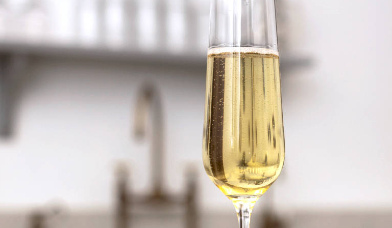 Closeup of glass of Prosecco on a kitchen worktop
