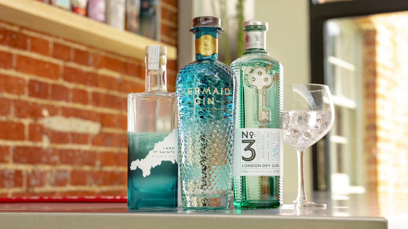 Line-up of gins available at Virgin Wines on a bar worktop
