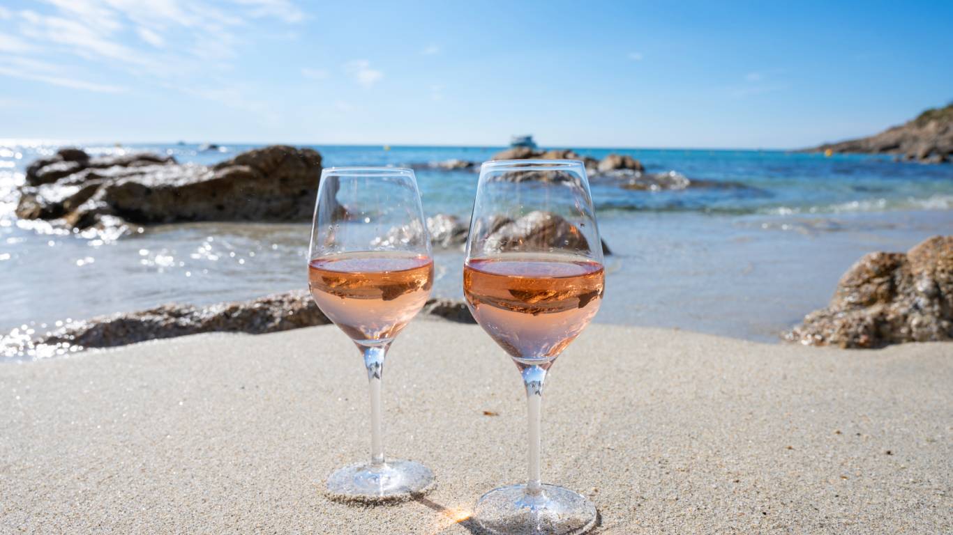 Summer time in Provence, two glasses of cold rose wine on sandy beach near Saint-Tropez, Var department in France