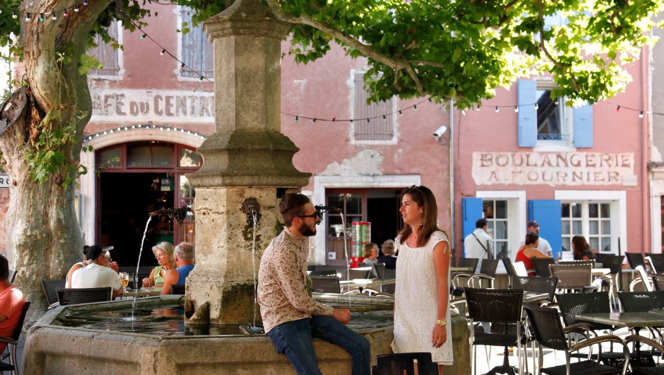 Two people in a town square in Rhone Valley