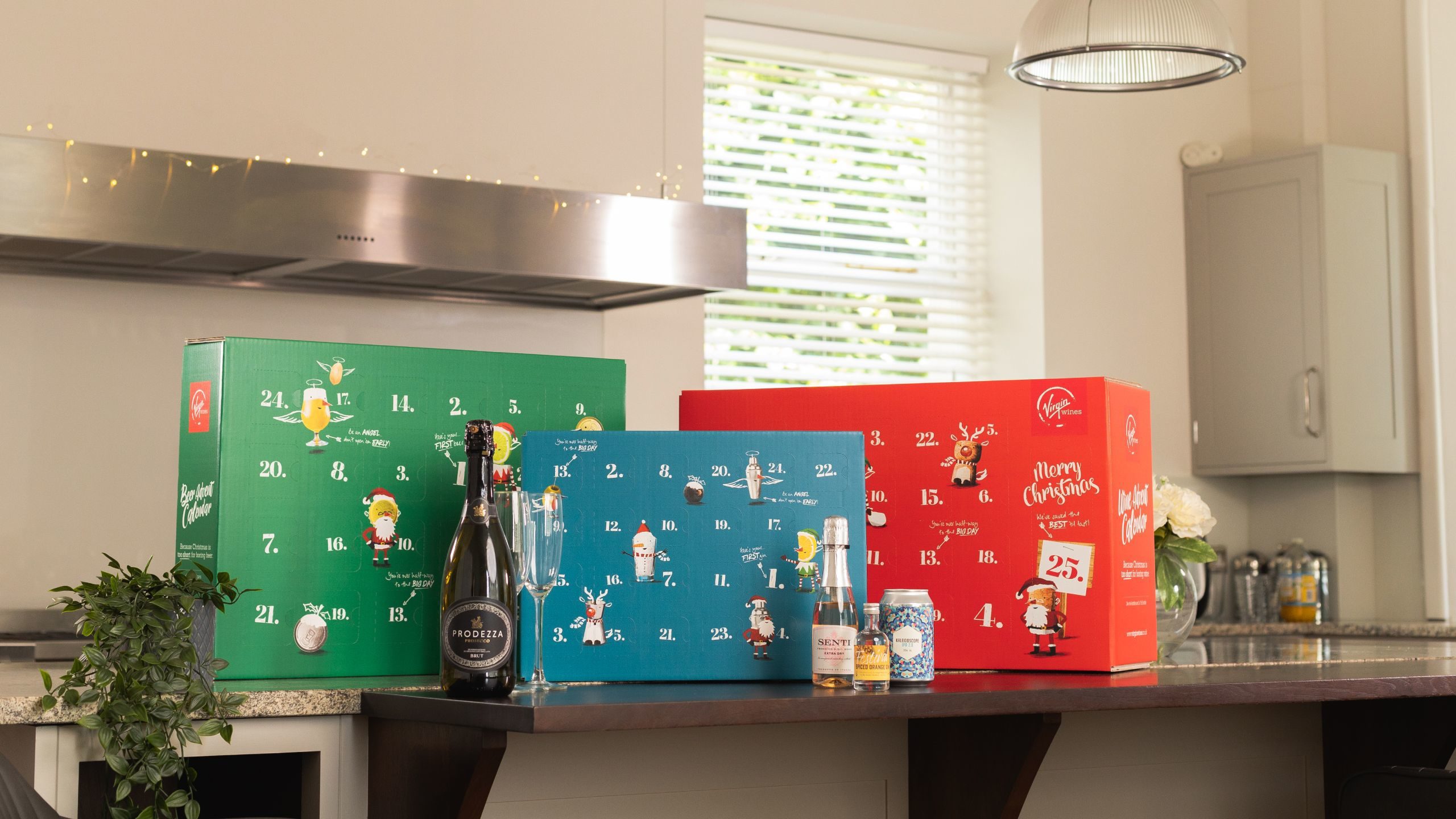 Wine, beer and gin advent calendars 2021 lined up on a kitchen worktop