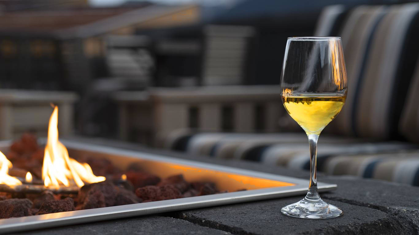 Glass of dessert wine outside by a firepit in the evening
