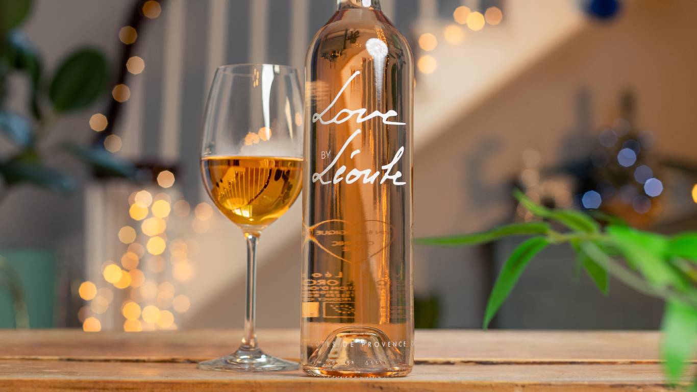 Love by Leoube Organic Cotes de Provence with a glass of rose wine in front of a festive staircase