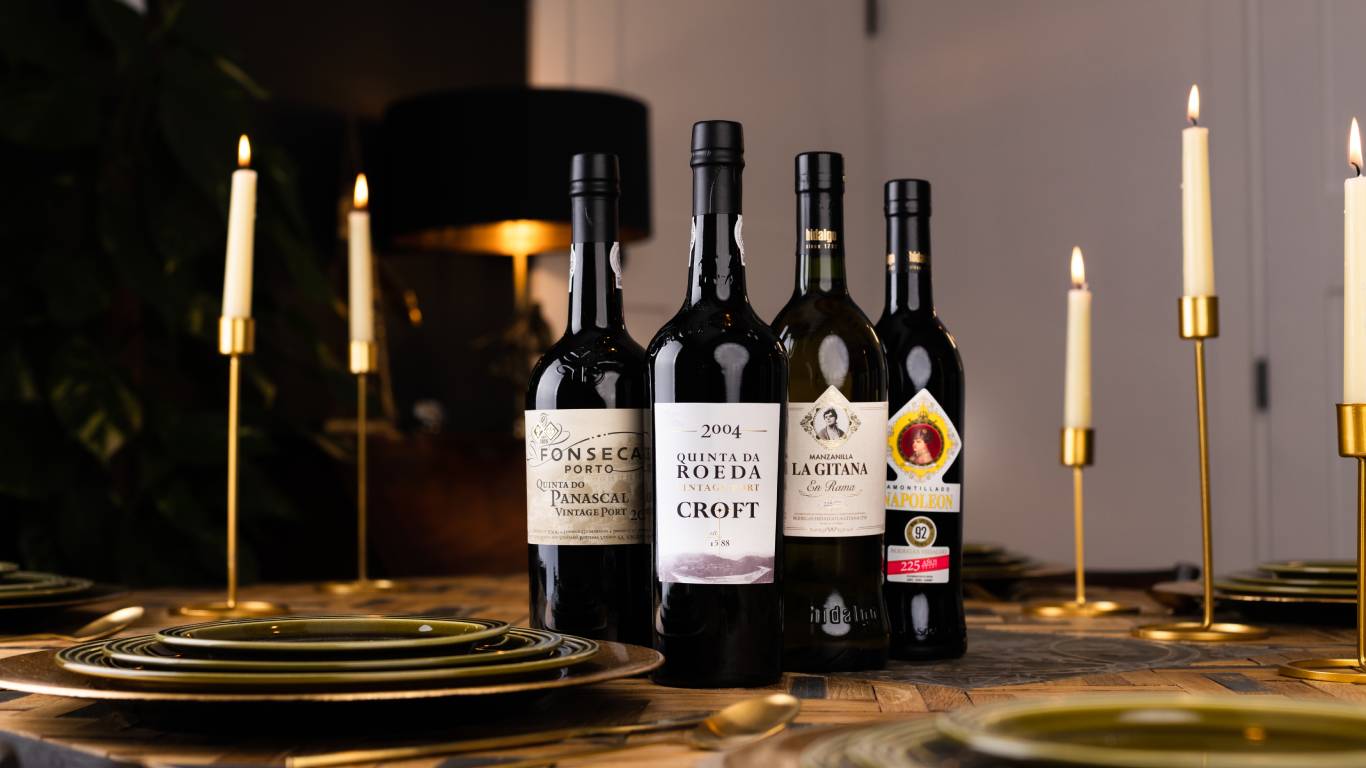 Photo of fortified wines on a dining table with candles