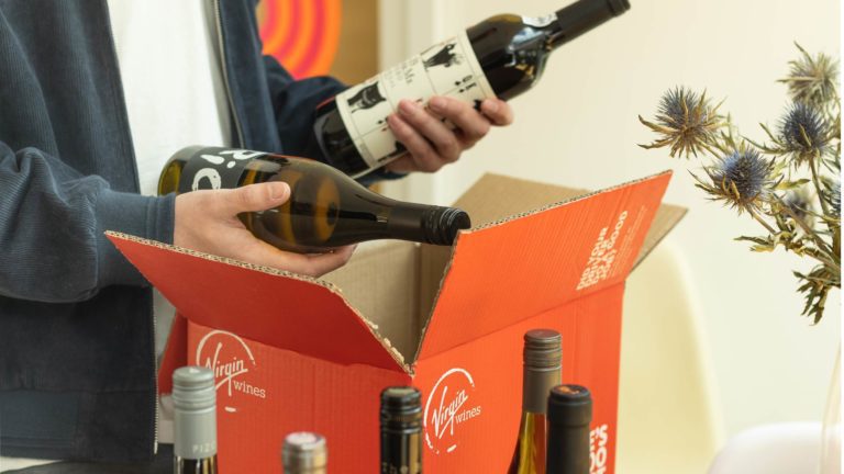 Someone unpacking wine from a box of Virgin Wines