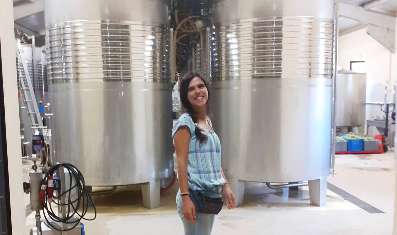 Winemaker Ana Coutinho of Quinta da Alorna Winery stood in between two fermentation tanks