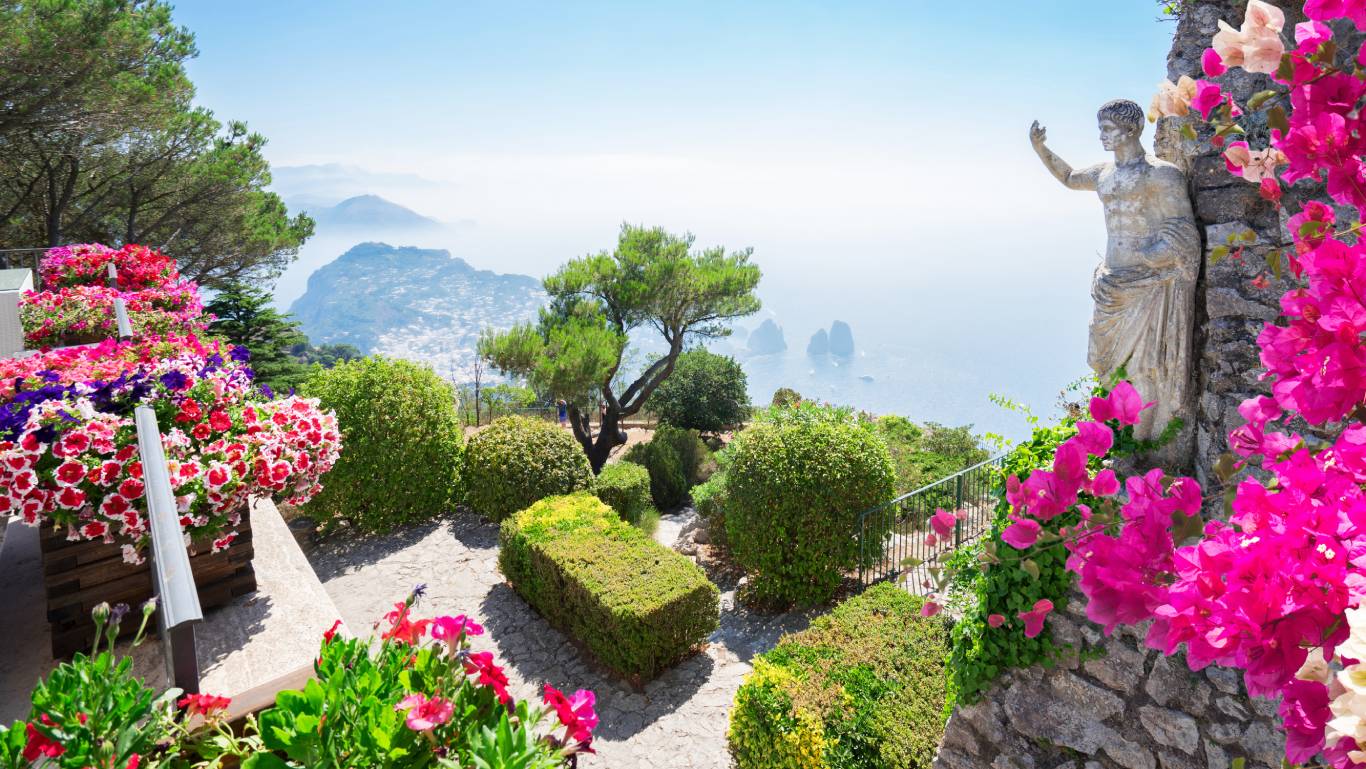 Views of the flowers and statues by the sea on Capri Island in Italy