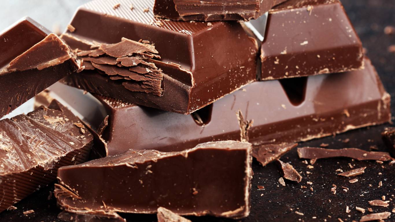 Chunks of milk chocolate on a dark surface