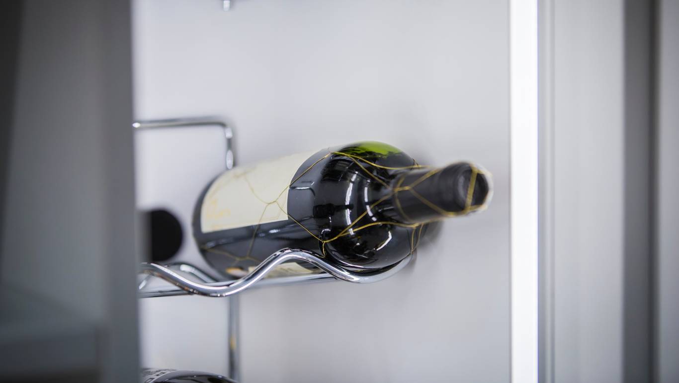 A bottle of red wine in a fridge