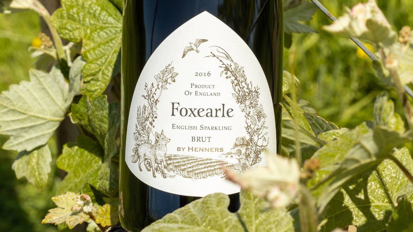 Close up of label on Henners Foxearle English Sparkling Brut, in amongst some vine leaves