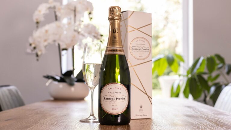 Bottle of Laurent Perrier on table with gift box