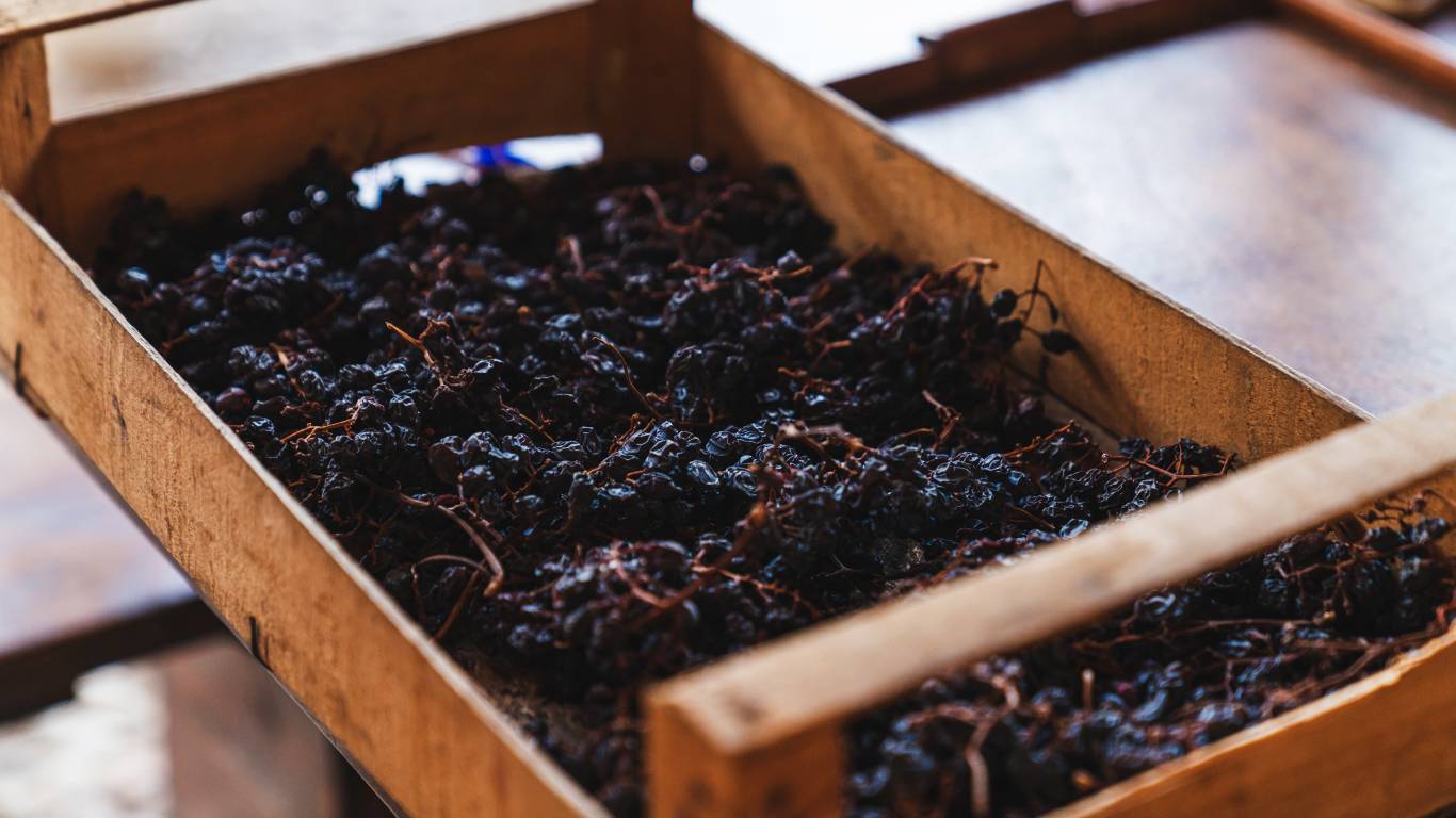 Dried red grapes in a wooden crate in Italy