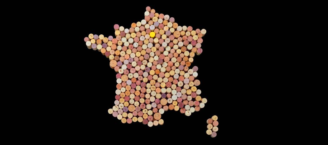 Map of France made with wine corks on a black background