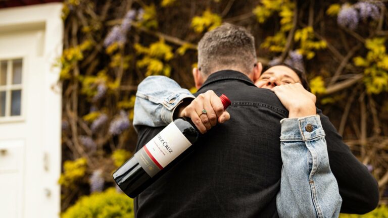 Father and daughter hugging while holding a Father's Day gift from Virgin Wines