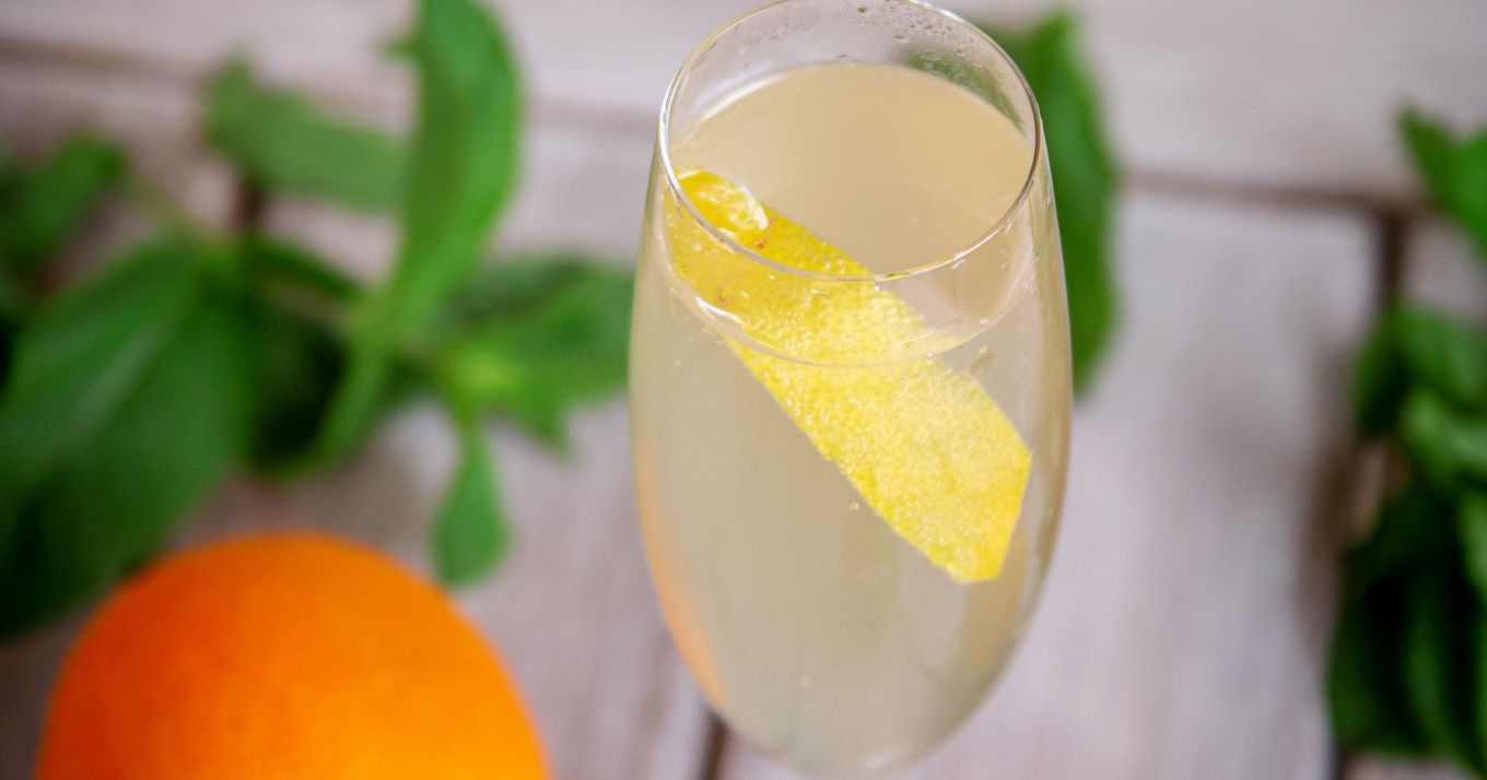 Italian 75 cocktail with slice of lemon - limoncello cocktail