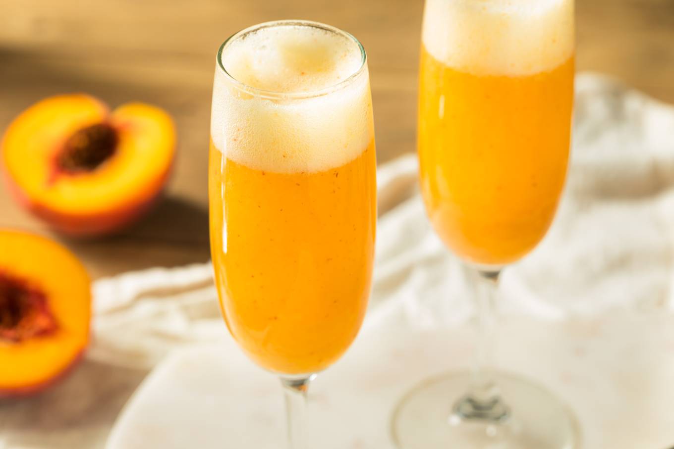 2 bellini cocktails served in champagne flutes