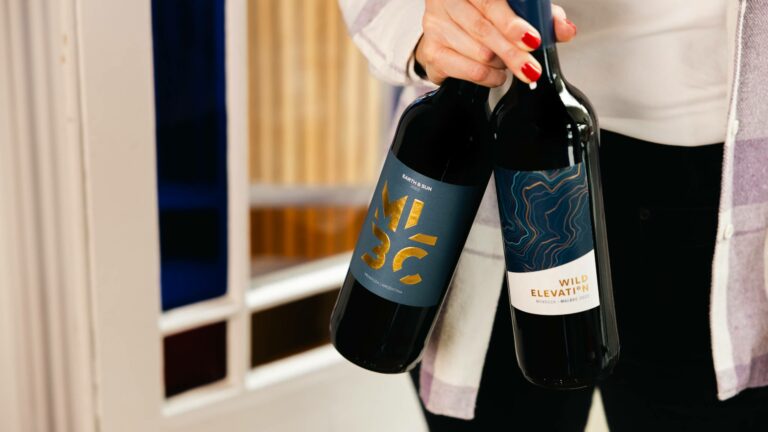 Woman holding two of the best Malbec wines available at Virgin Wines