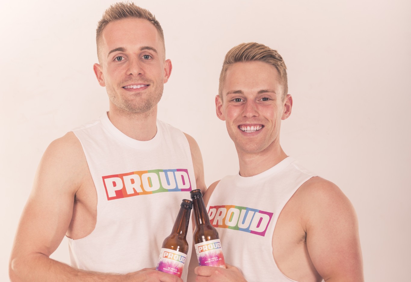 Sören and Ethan holding bottles of PROUD Beer for Atitude Magazine